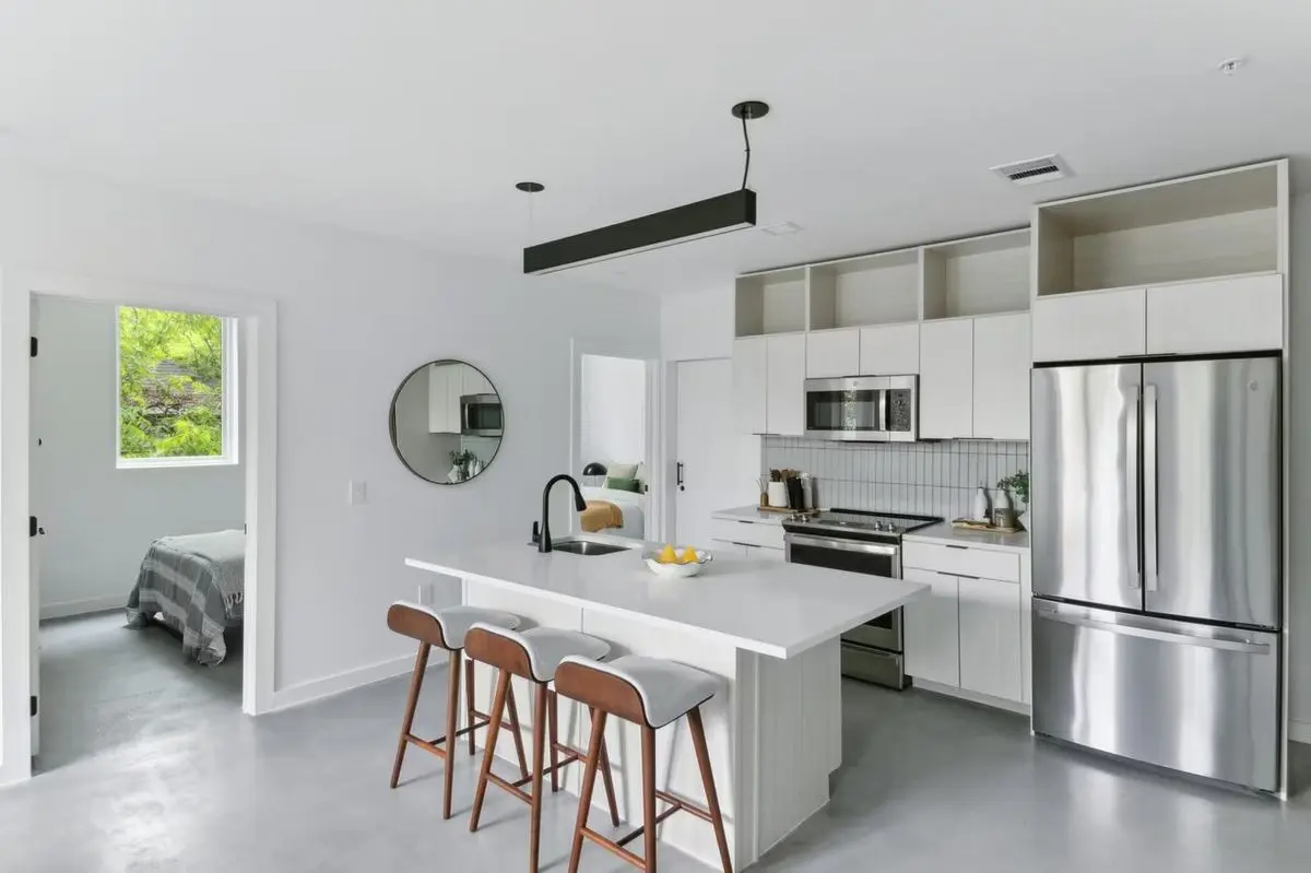 Open-concept kitchen and living area with bar seating at Capitol Living