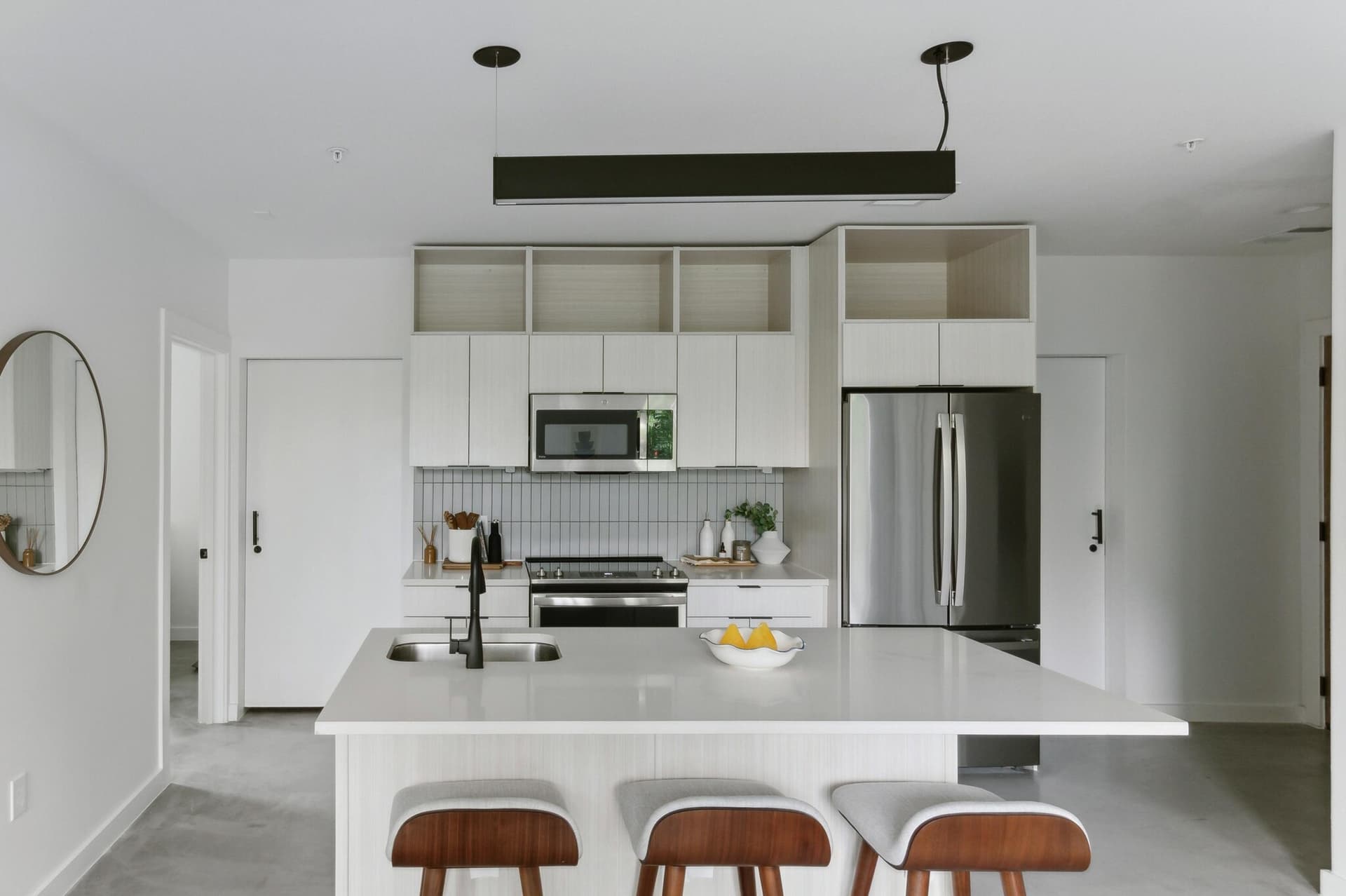 Modern kitchen with quartz countertops and stainless steel appliances at Capitol Living