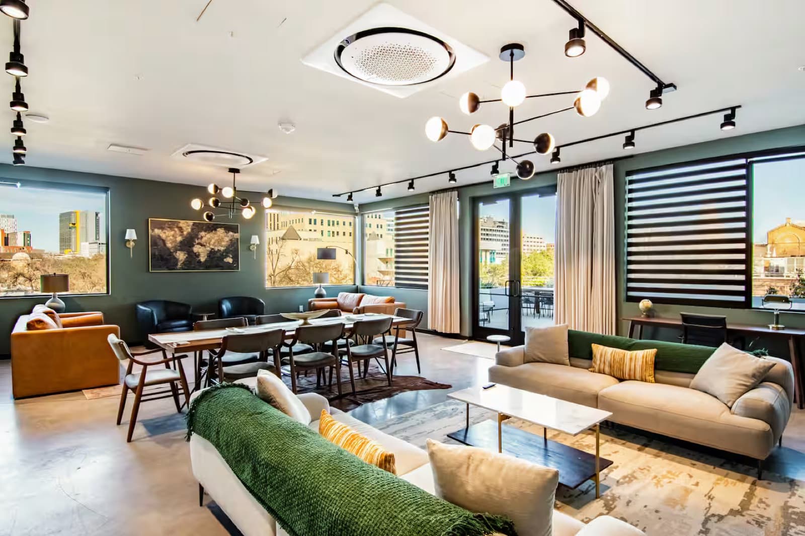 Capitol Living penthouse with city views, leather sofa, and designer lighting