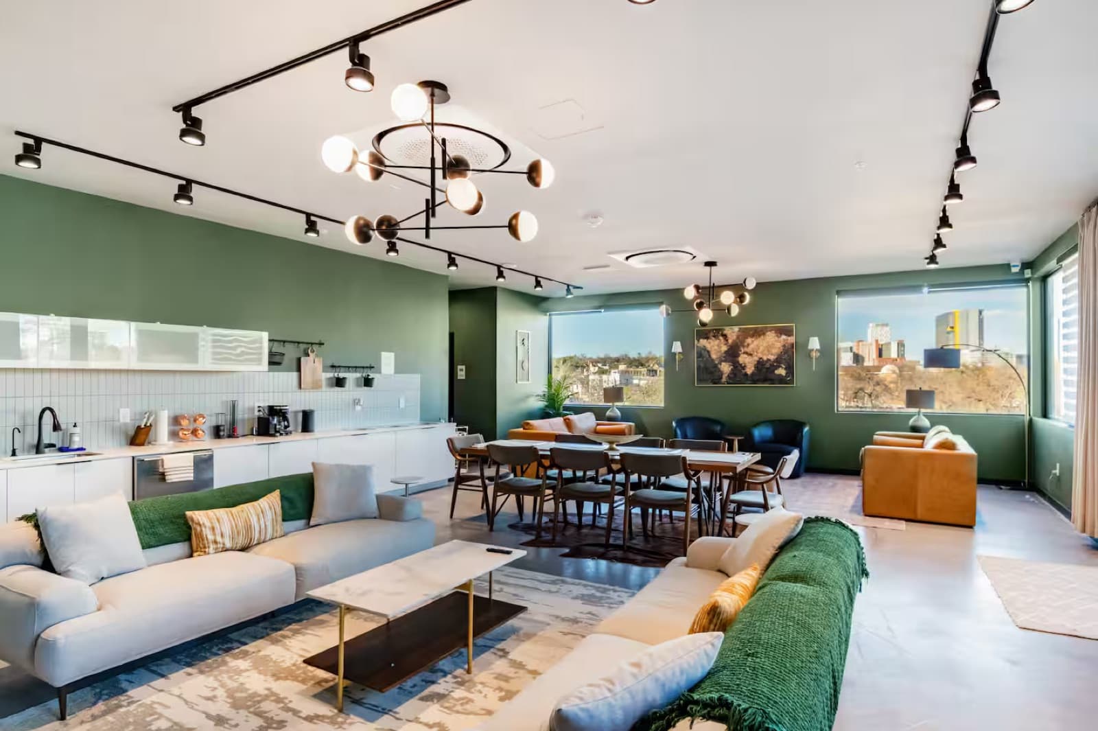 Capitol Living penthouse open floor plan with modern furniture and skyline views